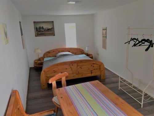a bedroom with a wooden bed and a wooden chair at Haus Engelskrug in Senheim