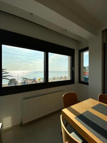 a dining room with a table and a view of the beach at Vit'S sea Villa in Siviri