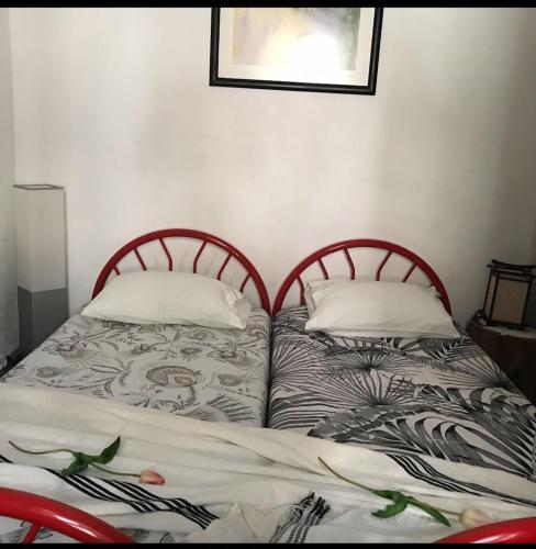 two beds sitting next to each other in a bedroom at A Casa da Avó... in São Vicente