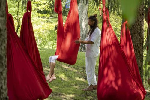 a woman standing next to a group of red tents at Grand Hotel Terme Di Comano in Comano Terme