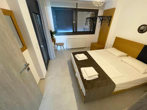 a bedroom with a bed with two towels on it at Vit'S sea Villa in Siviri