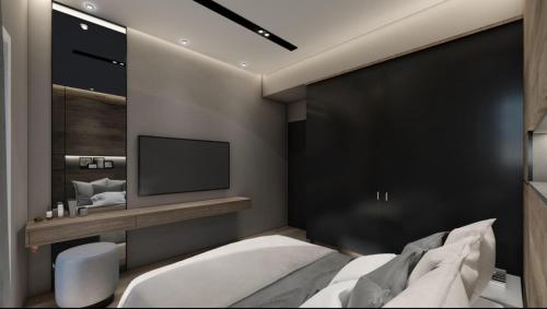 a bedroom with a bed and a tv on the wall at Luxury Townhouse Suite in Larisa