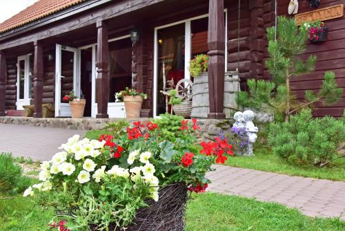 a basket of flowers in front of a house at Sodyba Sauletekis in Ignalina