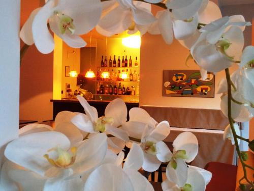 a bunch of white orchid flowers in a room at Hotel Casa Poli in Mantova