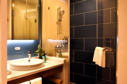 a bathroom with a sink and a shower at Holiday Inn Express Shanghai Gubei by IHG in Shanghai