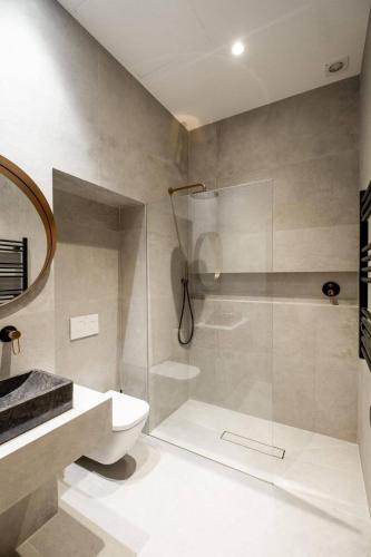 a bathroom with a shower and a toilet and a sink at La Posada de Juan in Cádiz