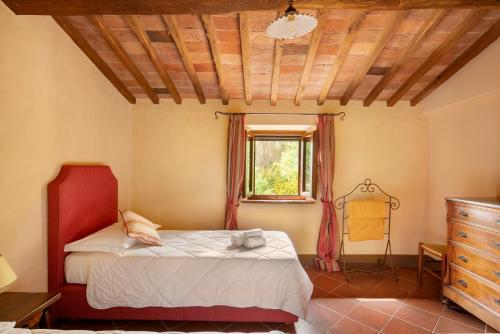 a bedroom with a bed and a window and a dresser at Castello di Bossi in Castelnuovo Berardenga