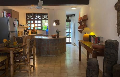 a kitchen with a bar in the middle of a room at Cabarete Beachfront Condos at Nanny Estate C-5 in Cabarete