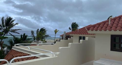 a balcony of a house with a view of the ocean at Cabarete Beachfront Condos at Nanny Estate C-5 in Cabarete
