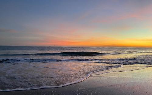 a view of the ocean at sunset with a beach at Cabarete Beachfront Condos at Nanny Estate C-5 in Cabarete