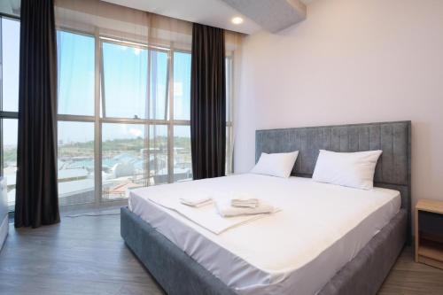 Postel nebo postele na pokoji v ubytování Stay Inn Apartments near Dalma Garden Mall