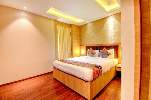 a bedroom with a bed in a room at FabHotel S Comfort Inn in Bangalore