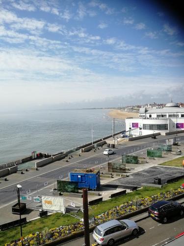 a view of a parking lot next to the ocean at Rowntree Seaview Holiday Flats small double room with no view in Bridlington