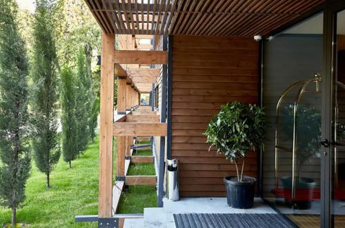 a wooden house with a wooden ladder on a porch at Urban Park Hotels in Tbilisi City