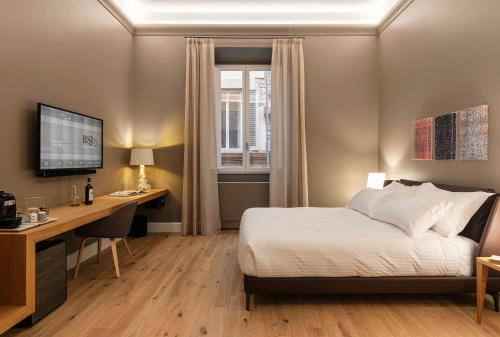 a bedroom with a bed and a desk and a computer at BSJ15-Borgo San Jacopo Room in Florence