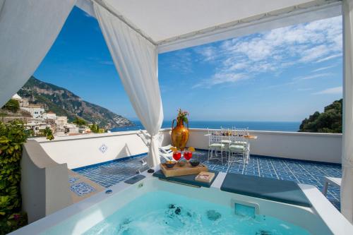 a hot tub on a balcony with a view of the ocean at Terrazza Zaffiro in Positano