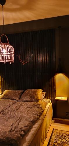 a bedroom with a large bed with a black headboard at Apartment Sanctus Nicolaus with sauna in Rovaniemi