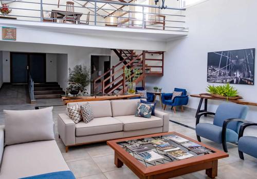 a living room with a couch and a coffee table at Bliss Hotel Vale do Café in Vassouras