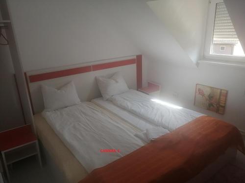 una camera da letto con un letto con lenzuola bianche e una finestra di REB/MAR RomSpa a Brad