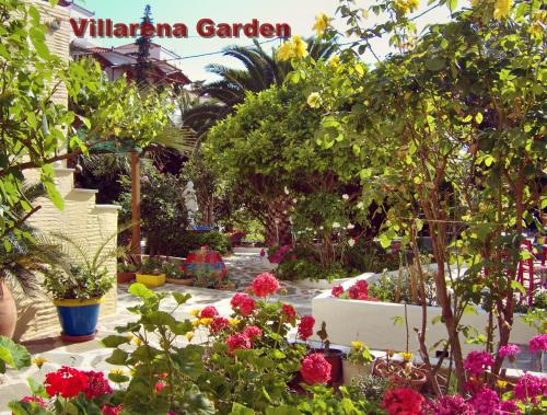a garden with flowers and trees and a sign at Villa Rena in Batsi