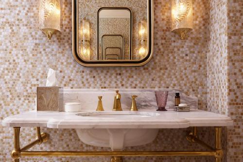 a bathroom with a sink and a mirror on the wall at NoMad London in London