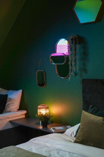 a bedroom with a bed and a table with a lamp at Timėjas in Ringaudai