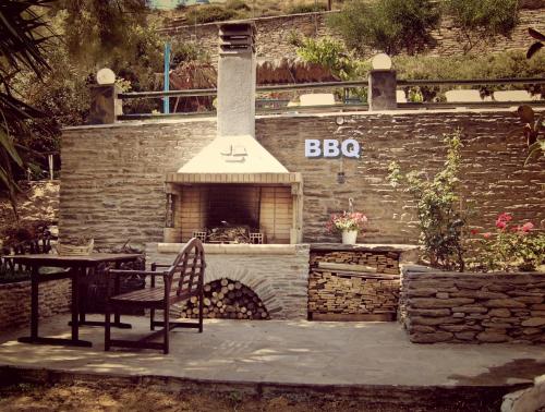 a brick oven with a table and a table and a chair at Villa Rena in Batsi