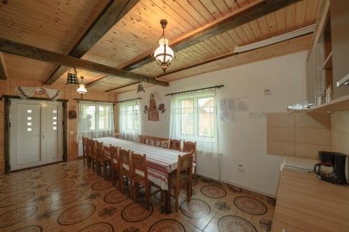 a dining room with a table and chairs in it at Casa Cupcea in Budeşti
