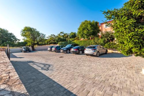 a row of cars parked in a parking lot at Apartment & Rooms Graciela in Rovinj