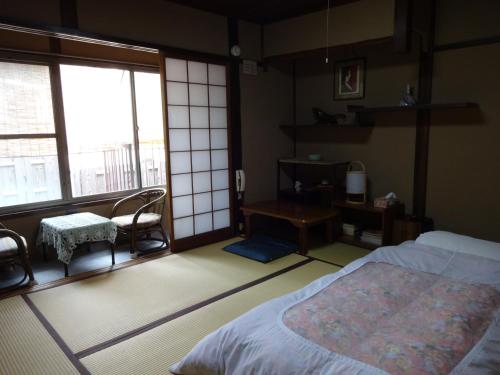 Postel nebo postele na pokoji v ubytování Ryokan Uemura