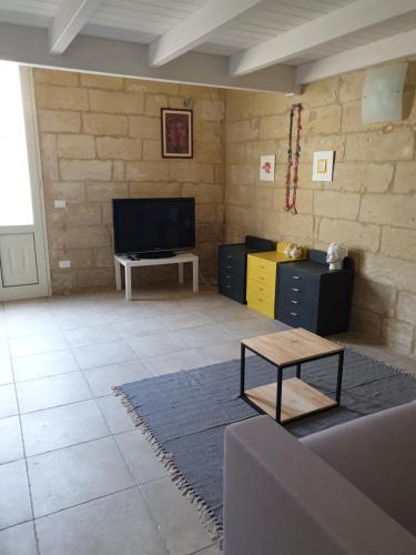 a living room with a flat screen tv and a table at 29BARRA31 in Merine