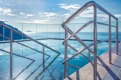a glass house with a view of the ocean at Windsor Leme Hotel in Rio de Janeiro