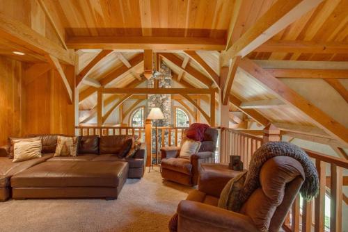 a living room with a couch and chairs in a house at Snowgrass Lodge - River, Mountain Views & Hot tub in Leavenworth