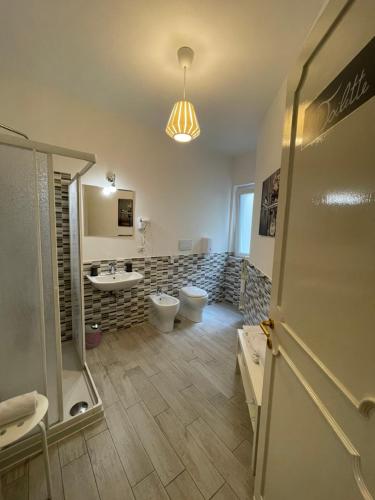 a bathroom with a toilet and a sink at Trastevere Sweet Rest in Rome