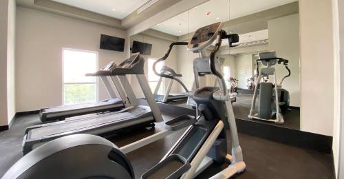 a gym with several tread machines in a room at Hotel MX mas cuautitlan Izcalli, Trademark by Wyndham in Cárdenas
