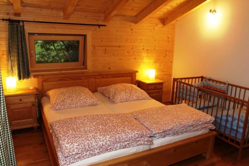 a bedroom with a bed with two pillows and a window at Ferienhaus Eller in Traunwalchen