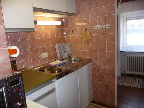 a small kitchen with a sink and a stove at Haus Gradwohl in Schladming