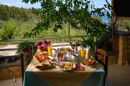 a table with food and drinks on it at Pension Elena in Ágios Nikólaos