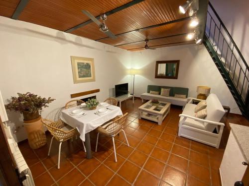 a living room with a table and a couch at La Buganvilla in Córdoba