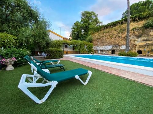 a green and white lounge chair next to a swimming pool at La Buganvilla in Córdoba