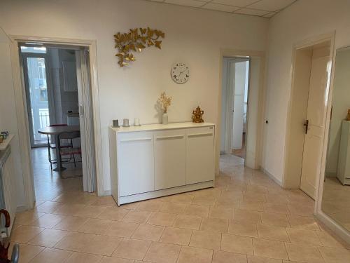 a kitchen with a counter and a clock on the wall at CasAmare di Carla in Savona