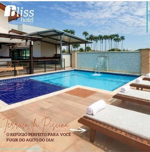 a swimming pool with two lounge chairs at Bliss Hotel Vale do Café in Vassouras