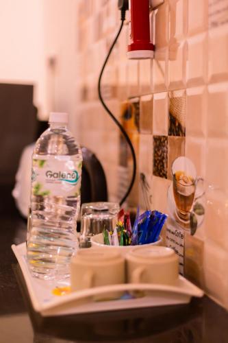 a bottle of water sitting on top of a table at Primavera Holiday Homes-FAMILY RUN GOAN GUEST HOUSE in Candolim