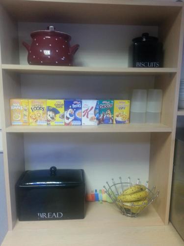 a shelf with a bowl of cereal and a basket of bananas at The Penrhyn in Blackpool