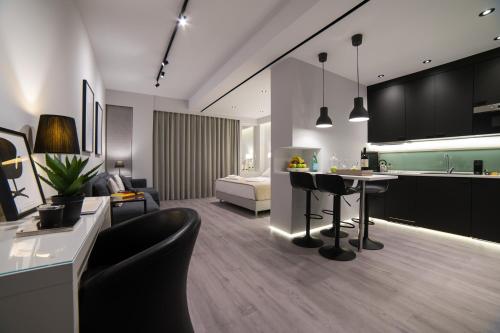 a room with a kitchen and a living room at JB Luxury Suites in Nafplio