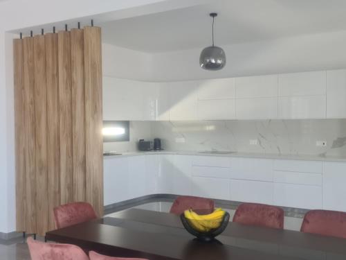 a kitchen with a black table and red chairs at Eva Luxury Villa in Lachi