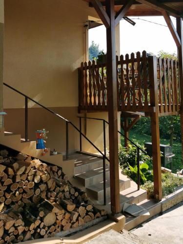a house with stairs and a pile of logs at Lipics Part in Murarátka