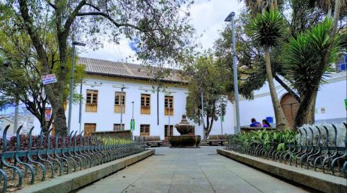 a white building with a fence in front of it at Hotel La Cierva de San Marcos in Quito