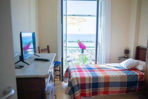 a bedroom with a bed and a computer on a desk at H11 SEA UNDER THE HOUSE - Arma di Taggia - Liguria in Taggia