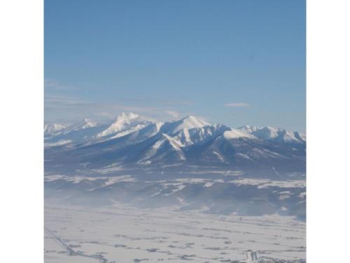 a view of a mountain from an airplane at ＦＵＲＡＮＯ ＮＡＴＵＬＵＸ ＨＯＴＥＬ - Vacation STAY 68188v in Furano